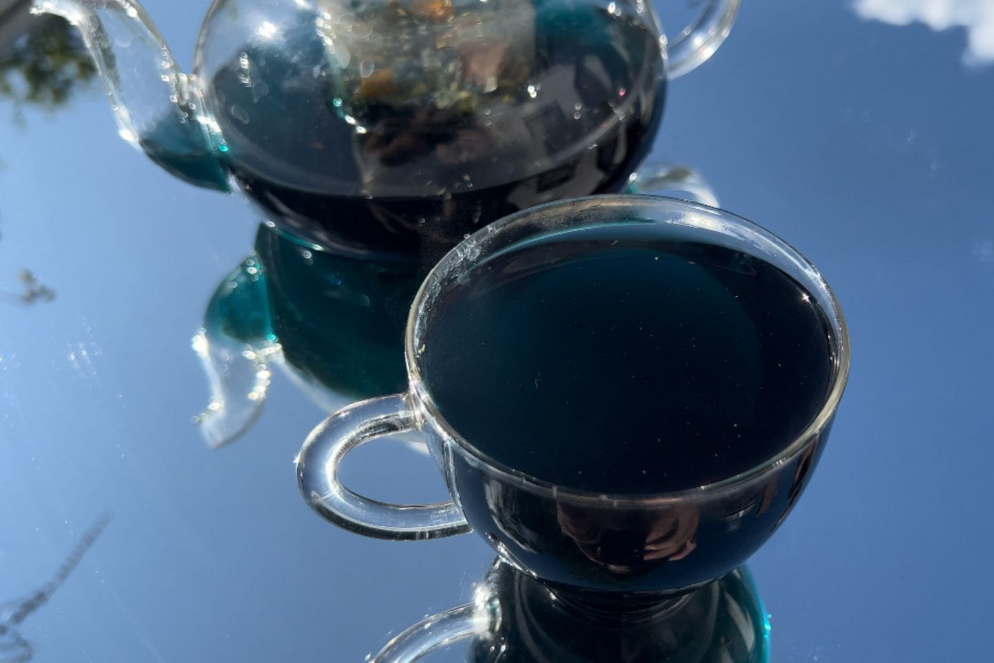 THE DREAMER Blue Potion Herbal Tea blue potion, cup of the dreamer herbal blend tea brewed in a beautiful lifestyle shot, nature