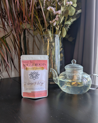 Spice & Roots pack beside a teapot, brewed and ready to pour
