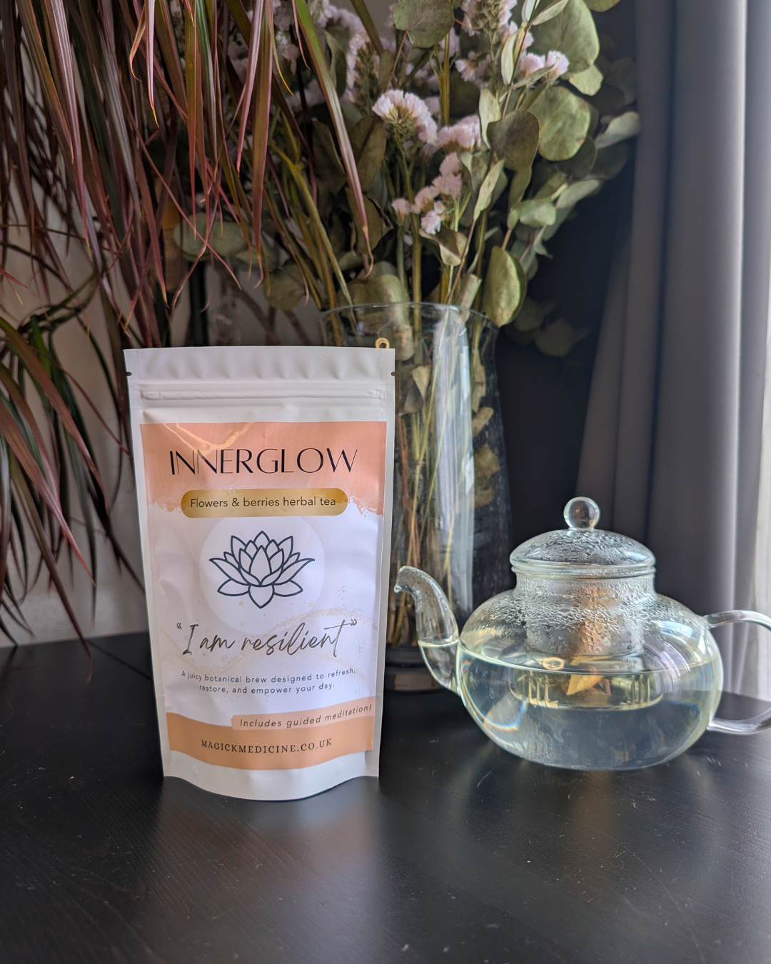 InnerGlow pack beside a teapot, brewed and ready to pour