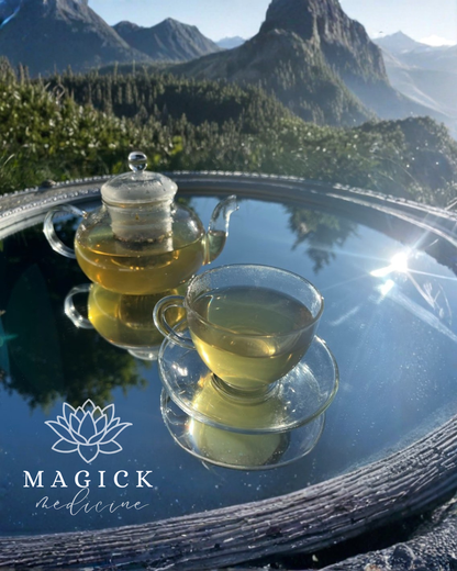 Sleep & Reset brewed in a glass teapot and cup, showing its pale gold-green colour