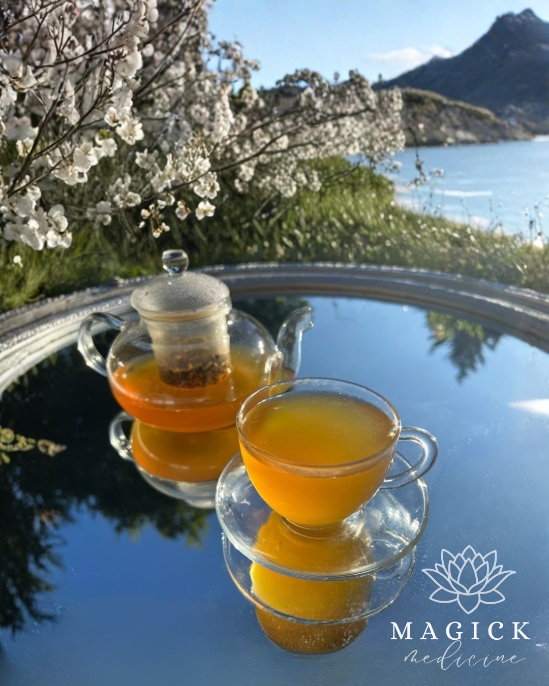 Spice & Roots brewed in a glass teapot and cup, showing its deep golden amber colour