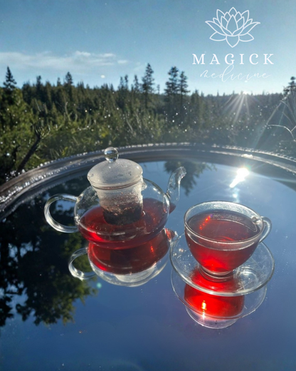 InnerGlow brewed in a glass teapot and cup, showing its deep ruby red colour